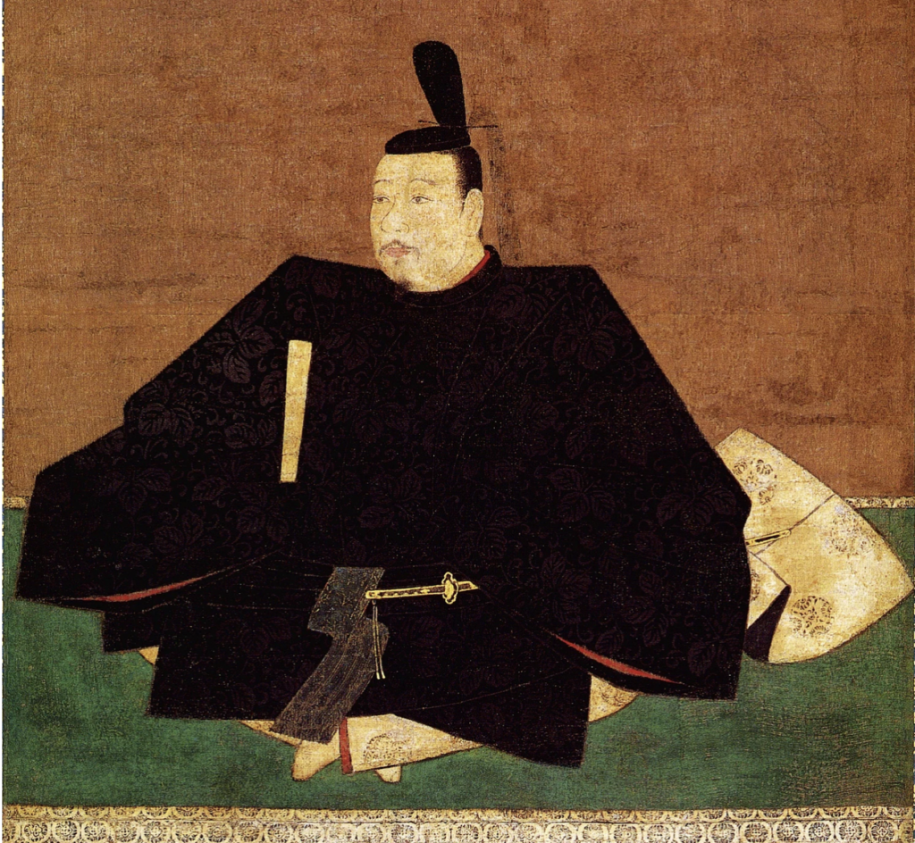 A portrait of Ashikaga Takauji. He is sitting down on a green rug, wearing all black with a red interior. He has a sword on his lap, ready to use that is black with a gold outline.